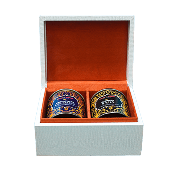 Two tea canisters, one labeled 'Muscatel of Darjeeling' and the other 'Kashmiri Saga', are presented in a decorative box.