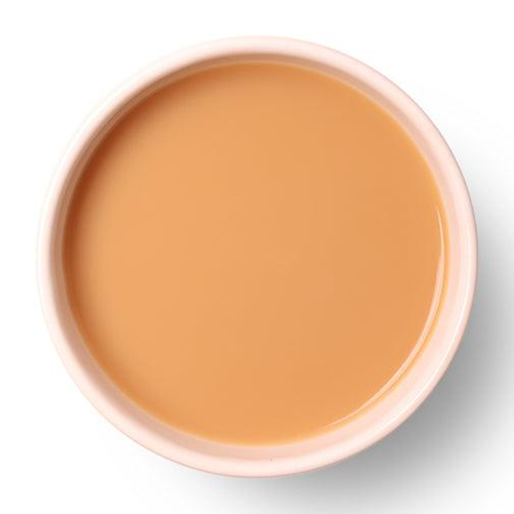 Golden amber liquor of Saffron Chai showcasing its smooth and aromatic character.
