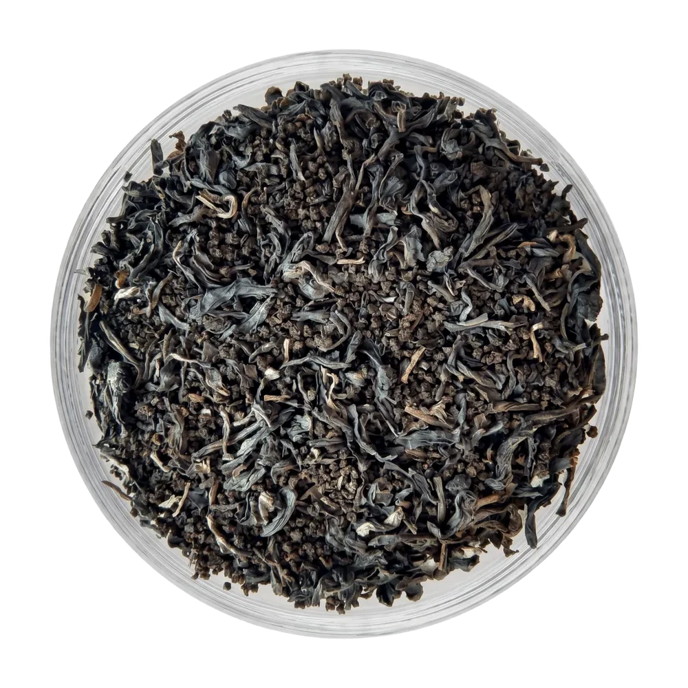 Close-up of Assam Vintage dry tea leaves showing dark, granular CTC and mix of traditional orthodox leaf.