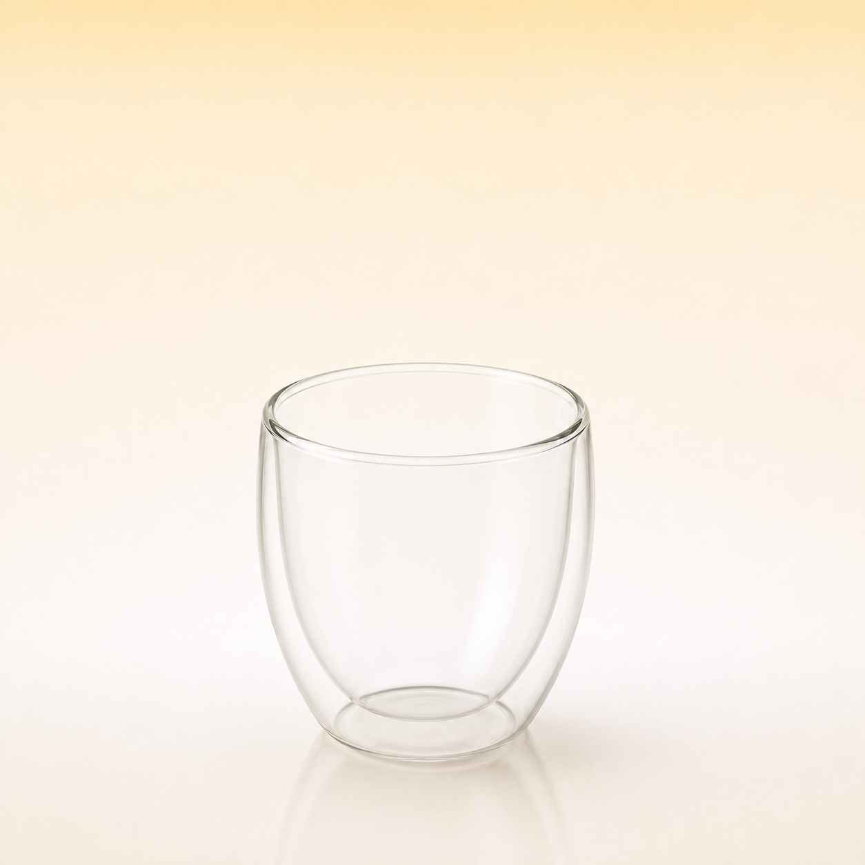 Aura Glass-A clear double-walled glass cup with a rounded shape, shown on a warm beige gradient background.