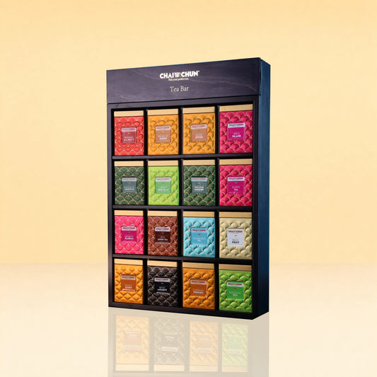 Chaichun Imperial TeaBar - A CHAICHUN Tea Bar display box containing 15 individually wrapped tea bars in a colorful grid, set against a warm beige gradient background.