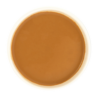 Cinnamon Zest tea brewed with milk, revealing a smooth, creamy caramel-brown liquor.