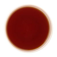 Freshly brewed Cinnamon Zest tea revealing a bright, warm amber liquor beautifully.