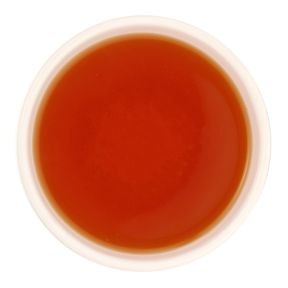 Freshly brewed Nimbu Spice tea showing a bright, clear golden amber liquor beautifully.