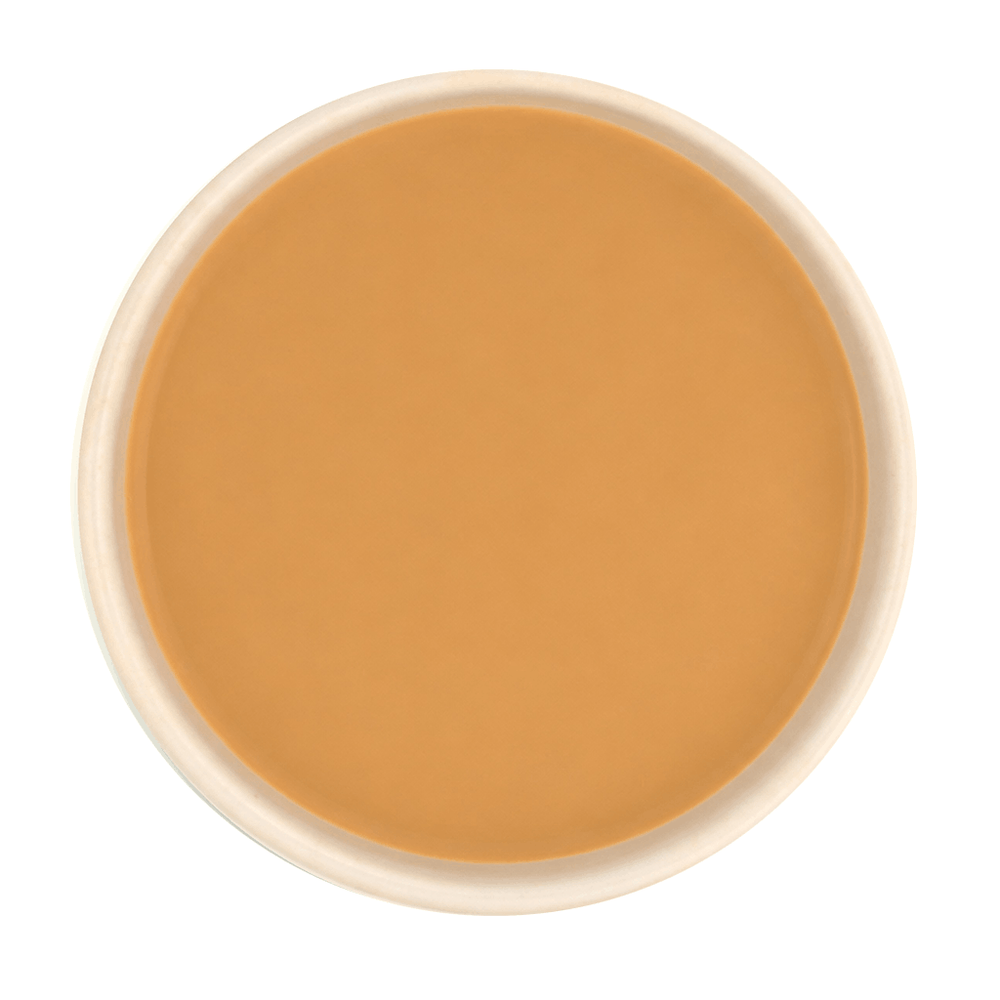 Freshly brewed Tulsi Adrak tea with milk, showcasing rich, creamy brown liquor beautifully.