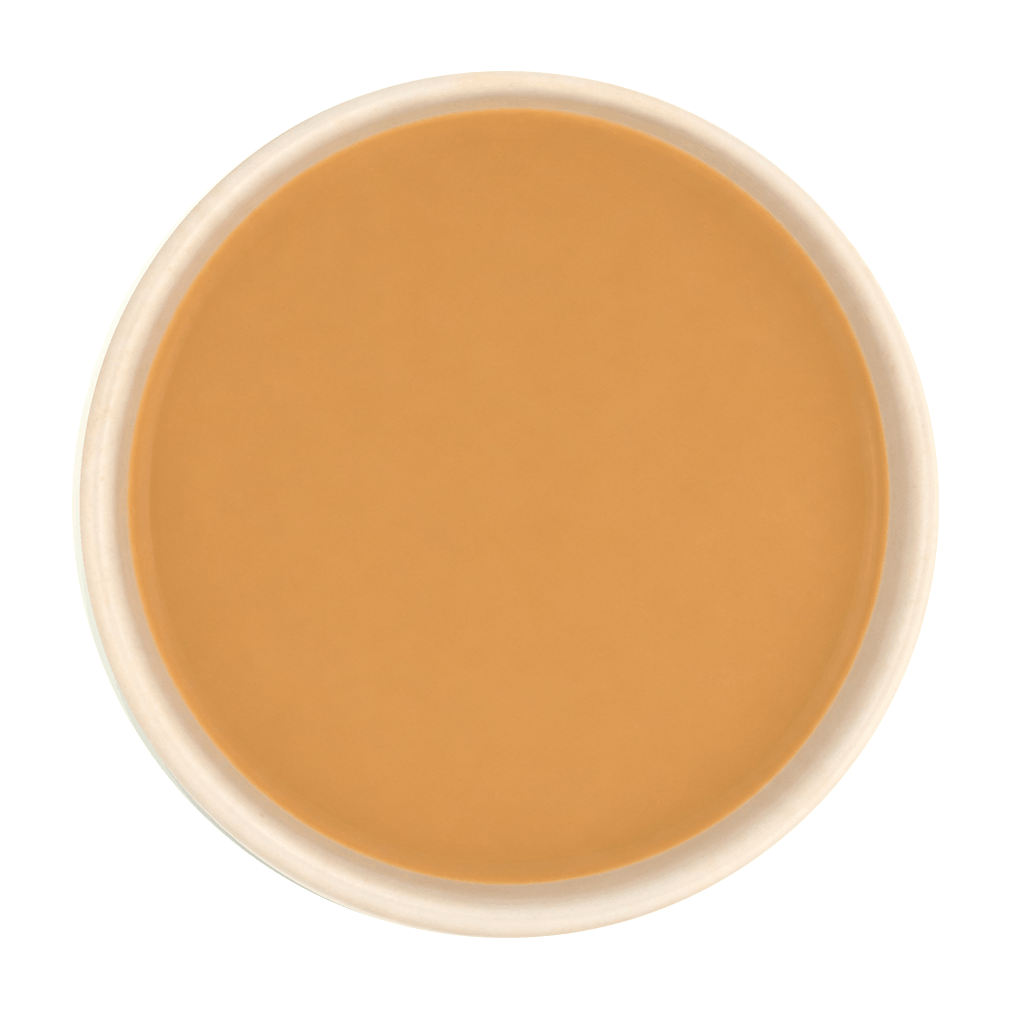Freshly brewed Tulsi Adrak tea with milk, showcasing rich, creamy brown liquor beautifully.