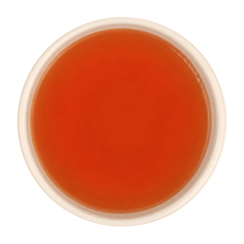 Freshly brewed Tulsi Adrak tea showing a bright, clear amber-brown liquor beautifully.