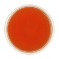Freshly brewed Tulsi Adrak tea showing a bright, clear amber-brown liquor beautifully.