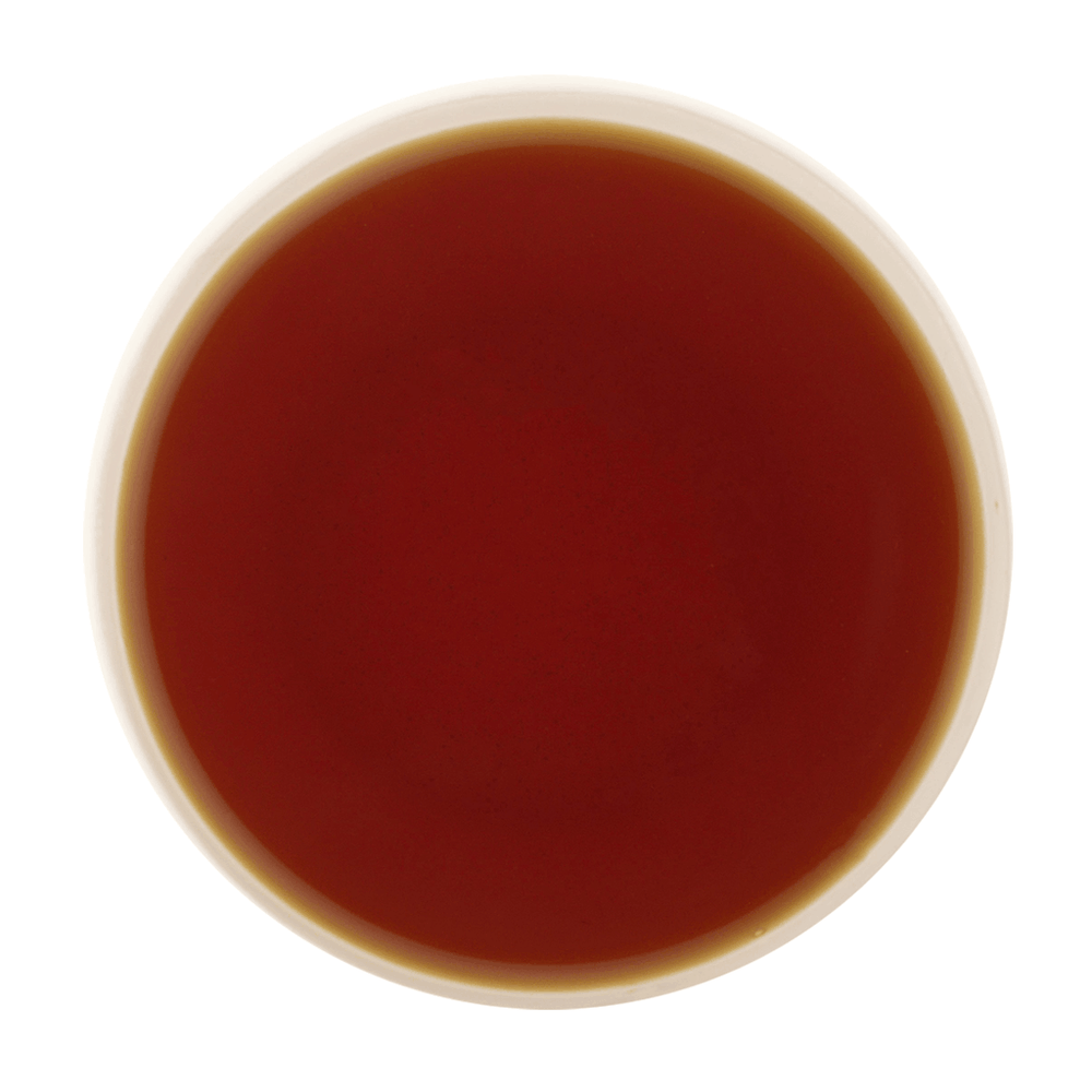 Amber liquor of Cardamom Tea showcasing its smooth body and refreshing cardamom character