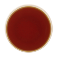Amber liquor of Cardamom Tea showcasing its smooth body and refreshing cardamom character
