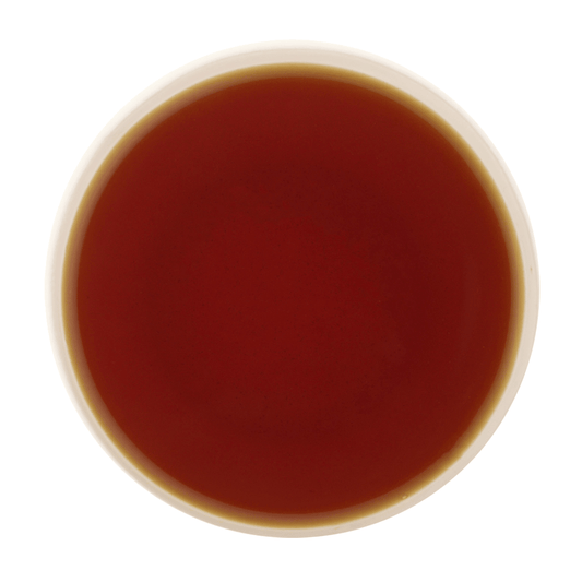 Amber liquor of Cardamom Tea showcasing its smooth body and refreshing cardamom character
