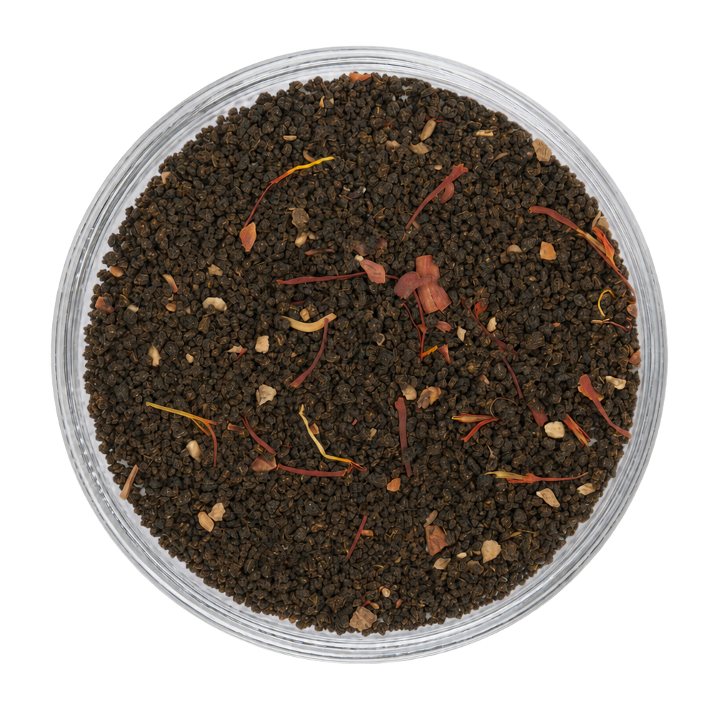 Close-up appearance of Saffron Chai showing dark tea leaves, saffron threads, and warming spices.