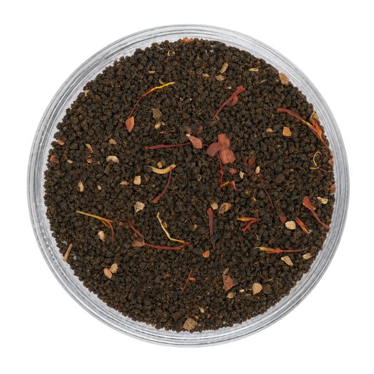 Close-up appearance of Saffron Chai showing dark tea leaves, saffron threads, and warming spices.