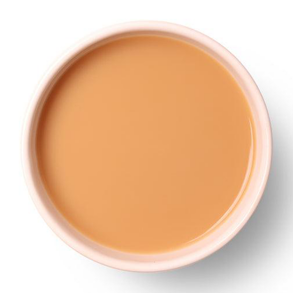 Golden amber liquor of Saffron Chai showcasing its smooth and aromatic character.