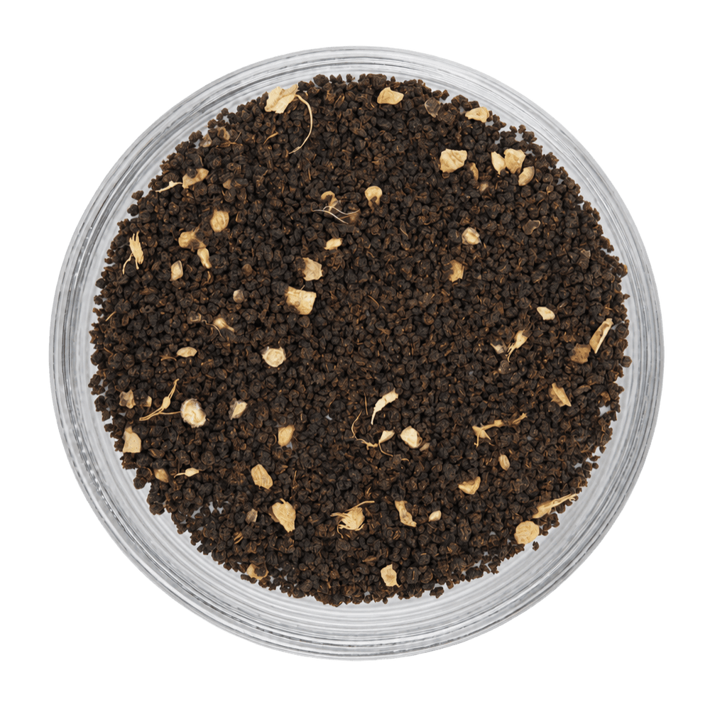 Close-up of ground black pepper in a transparent container on a white background