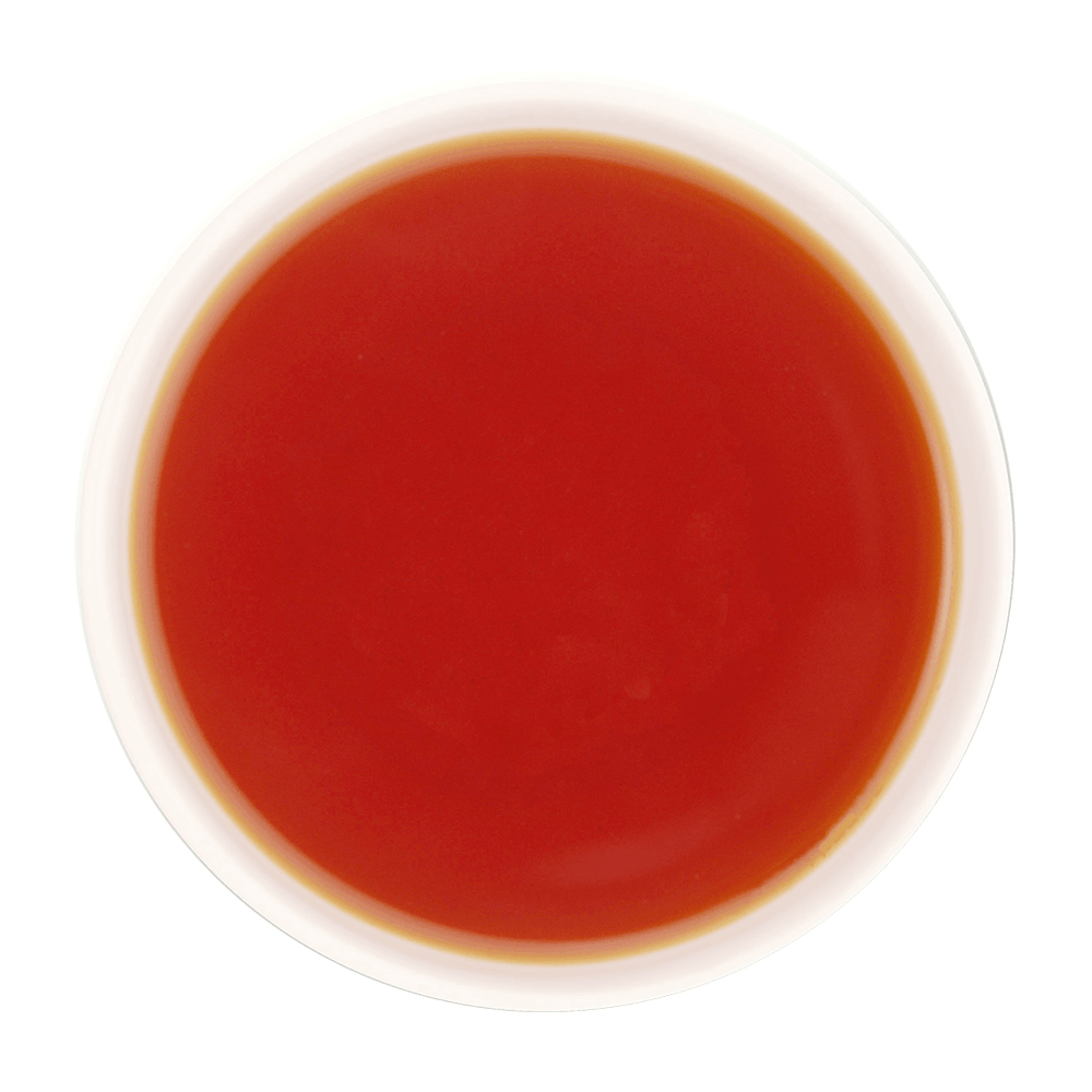 A freshly brewed cup of Clove Protect Tea without milk, displaying a clear, bright reddish-brown to amber tea liquor with a smooth and inviting appearance.